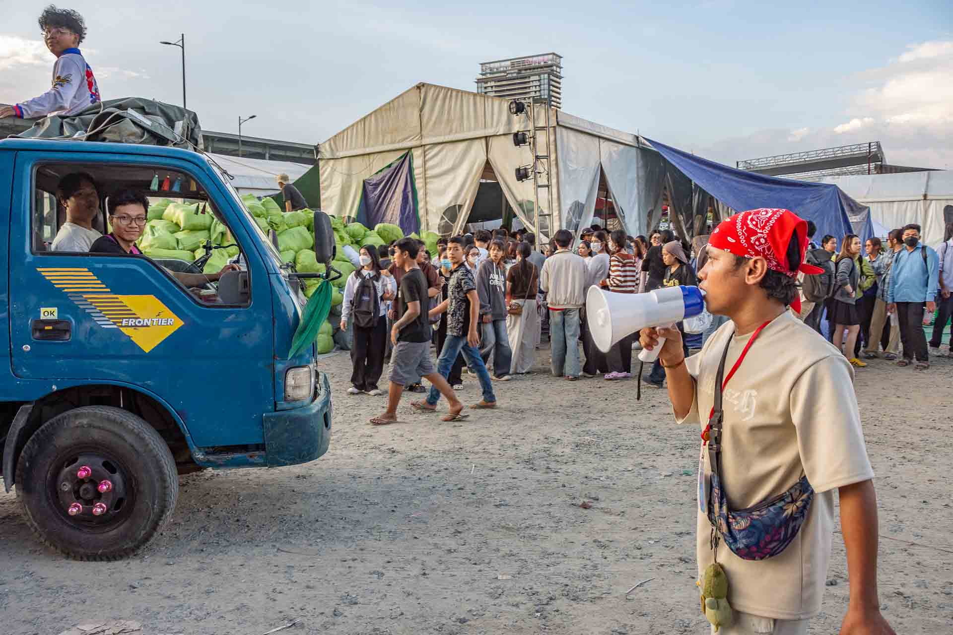 Vehicles arrive to deliver supplies at a donation centre in Beung Kok, Phnom Penh, Cambodia.